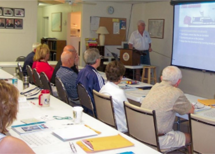 Photo, classroom with instructor and several adult students